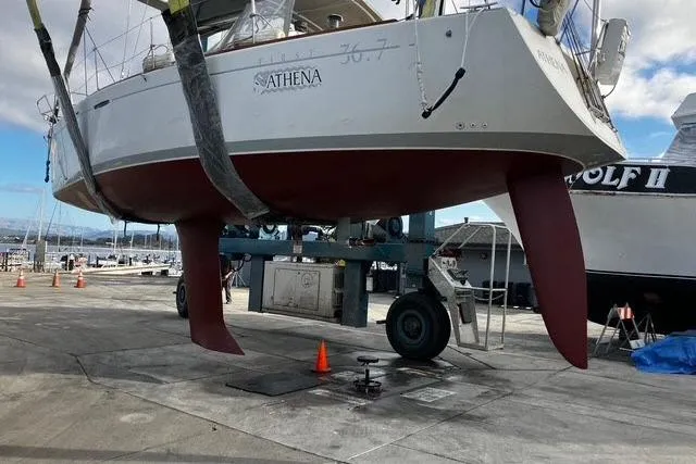 Slide: The Image of Beneteau First 36.7 sailboat from 2002 on a lift at a marina. - 16
