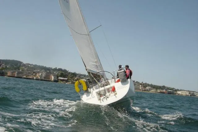 Slide: The Image of Sailing Beneteau First 36.7, 2002 model, on open water with crew onboard. - 18