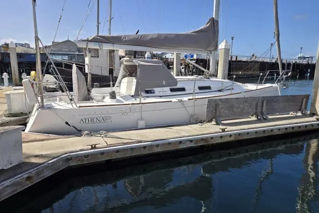 Slide: The Image of 2002 Beneteau First 36.7 sailboat docked at a marina, featuring sleek design and covered sails. - 5