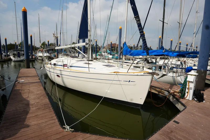 The Image of Sailboat Bavaria 37 C, 2007 model, docked at marina with other boats. - 1