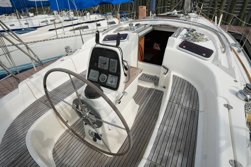 Slide: The Image of Cockpit of a 2007 Bavaria 37 C sailboat with steering wheel and navigation instruments. - 11