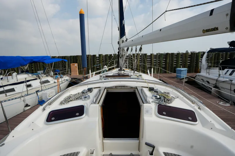 Slide: The Image of 2007 Bavaria 37 C sailboat docked, showing deck and rigging details. - 12