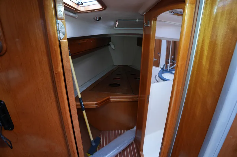 Slide: The Image of Interior cabin view of a 2007 Bavaria 37 C sailboat, featuring wooden finishes and a compact layout. - 15