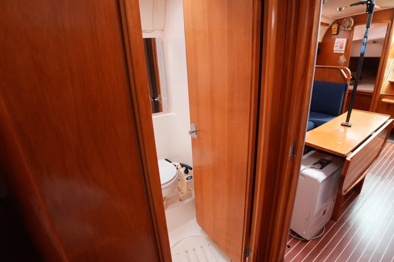 Slide: The Image of Interior of 2007 Bavaria 37 C yacht showing wooden cabin and compact bathroom. - 18