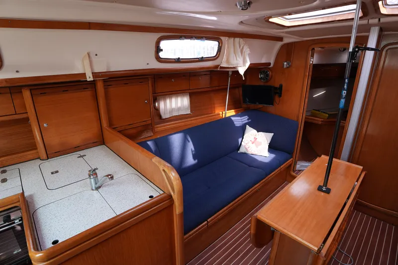 Slide: The Image of Interior of 2007 Bavaria 37 C yacht with wooden cabinetry and blue seating. - 21