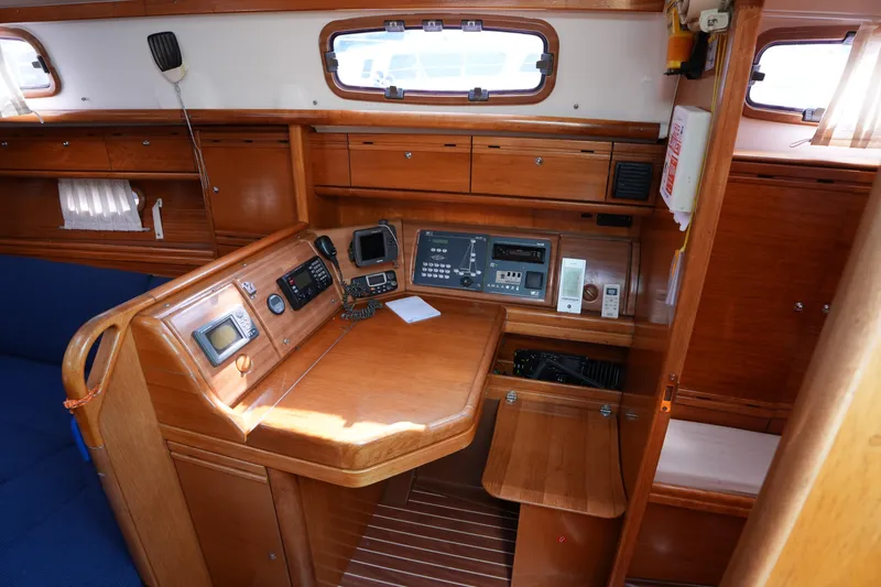 Slide: The Image of 2007 Bavaria 37 C yacht interior with navigation equipment and wooden cabinetry. - 22