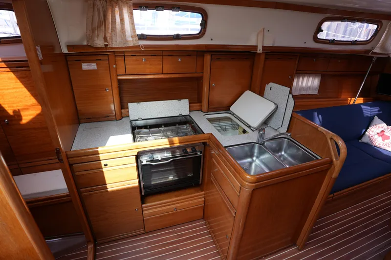 Slide: The Image of Interior of 2007 Bavaria 37 C yacht kitchen with wooden cabinetry and dual sink. - 26