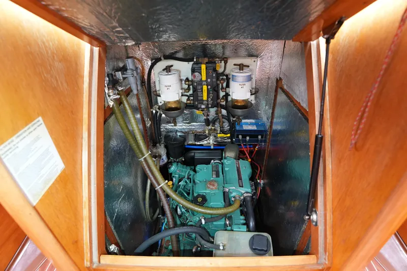 Slide: The Image of Engine compartment of a 2007 Bavaria 37 C sailboat, showcasing mechanical components and filters. - 29