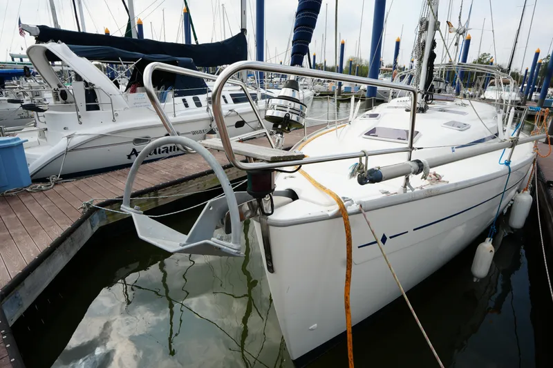 Slide: The Image of 2007 Bavaria 37 C sailboat docked in a marina, surrounded by other boats. - 6