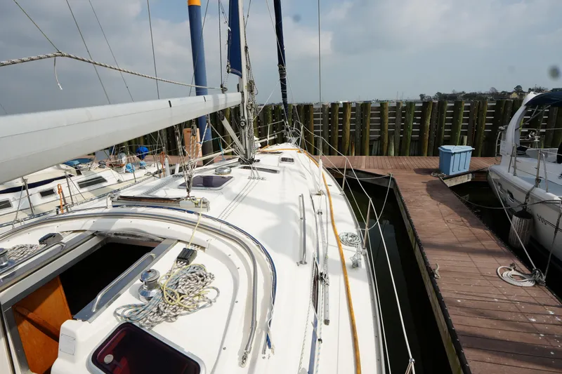 Slide: The Image of 2007 Bavaria 37 C sailboat docked at marina, showcasing deck and rigging details. - 8