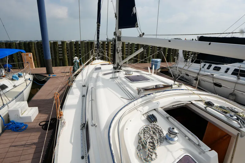 Slide: The Image of Sailboat Bavaria 37 C, 2007 model, docked at marina with visible deck and rigging. - 9