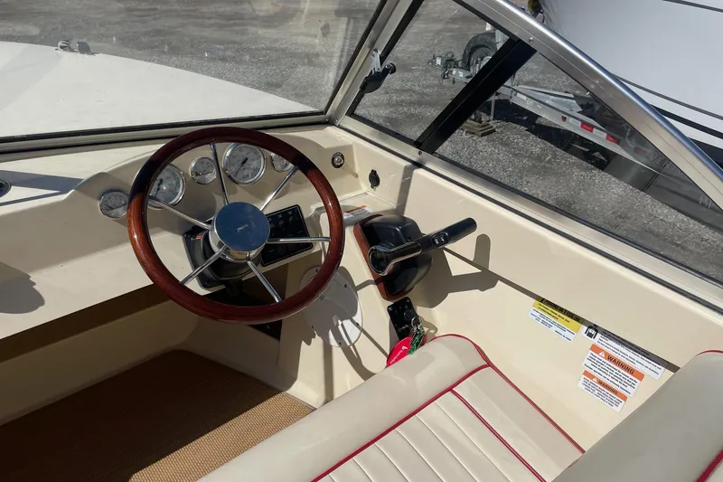 Slide: The Image of 2018 Rossiter 17 Closed Deck boat interior with steering wheel and control panel. - 10