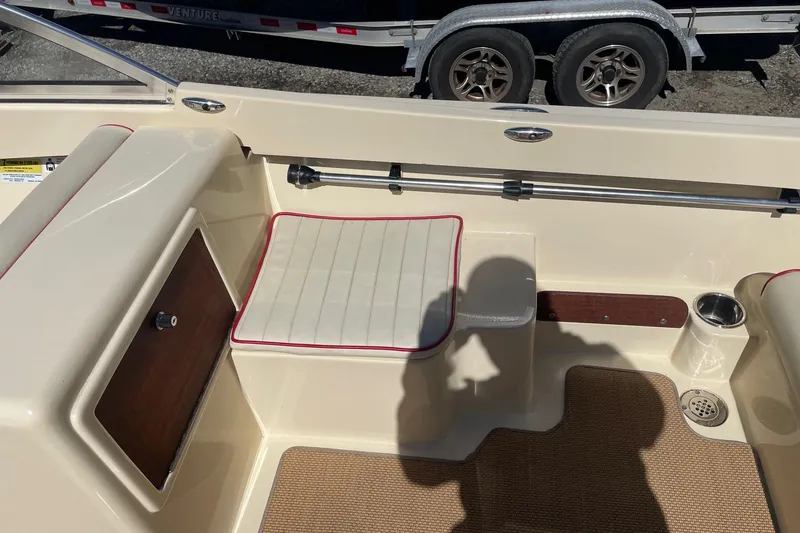 Slide: The Image of 2018 Rossiter 17 Closed Deck interior with cushioned seating and storage compartment. - 12