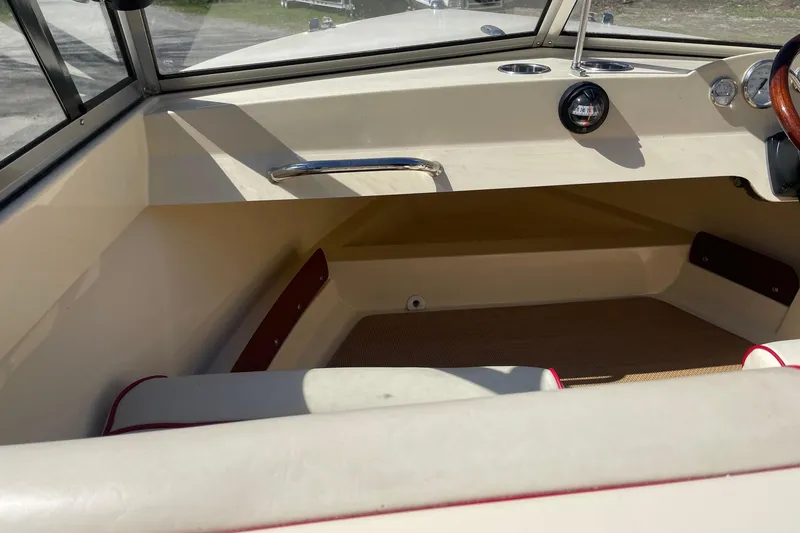 Slide: The Image of 2018 Rossiter 17 Closed Deck interior with beige upholstery and wooden steering wheel. - 13