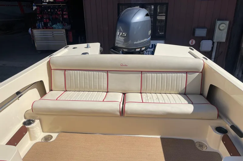 Slide: The Image of 2018 Rossiter 17 Closed Deck boat interior with cushioned seating and outboard motor. - 14