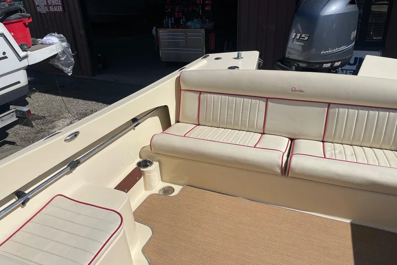 Slide: The Image of 2018 Rossiter 17 Closed Deck boat interior with beige seating and Yamaha 115 engine. - 15