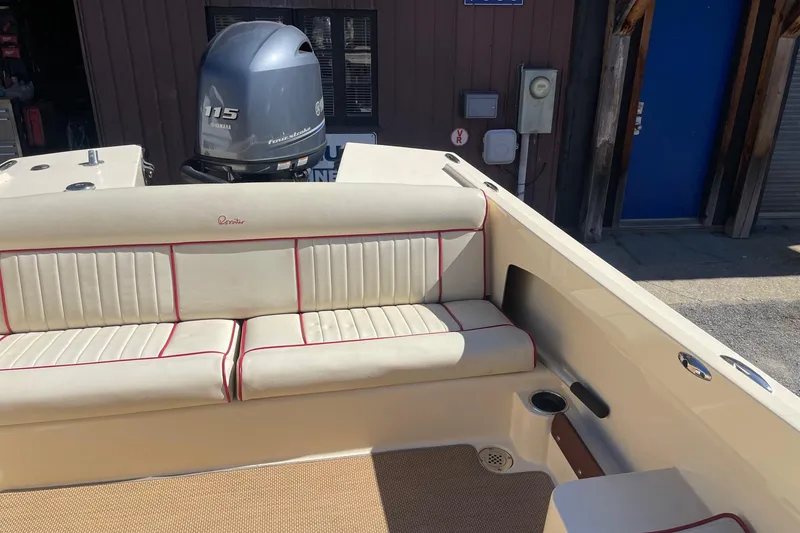 Slide: The Image of 2018 Rossiter 17 Closed Deck boat interior with Yamaha 115 engine, featuring beige seating. - 16