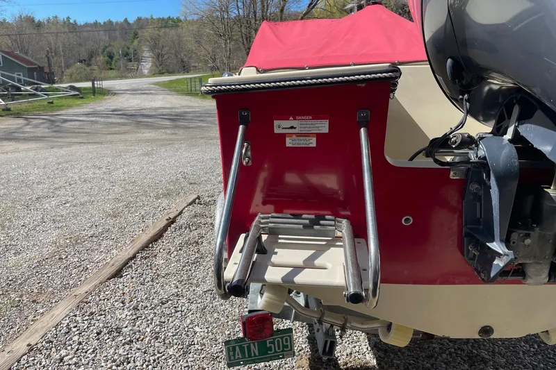 Slide: The Image of Rear view of 2018 Rossiter 17 Closed Deck boat with ladder and outboard motor. - 18
