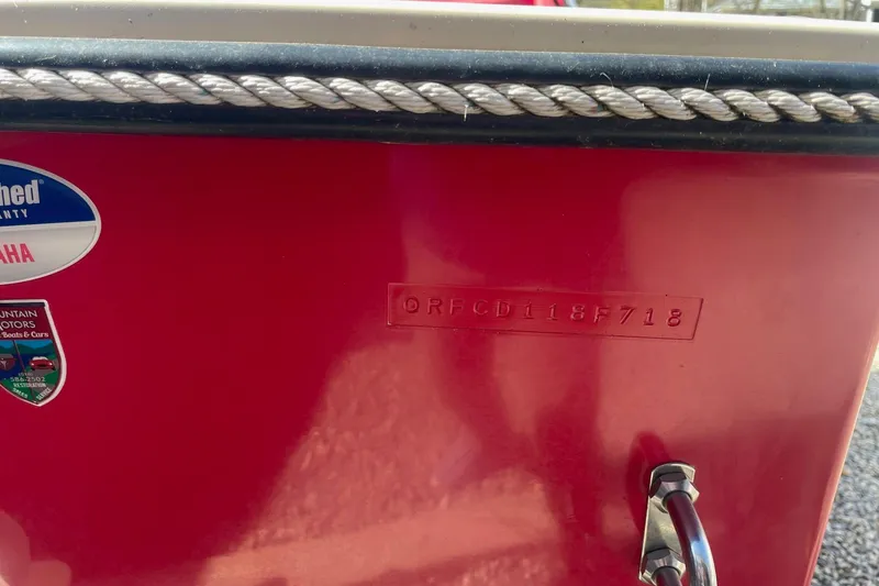 Slide: The Image of Red 2018 Rossiter 17 Closed Deck boat with visible serial number and Yamaha warranty sticker. - 6