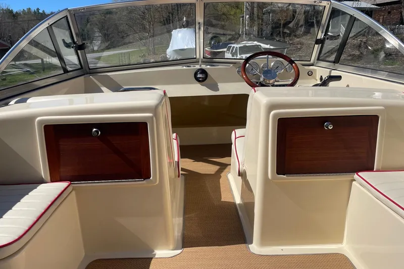 Slide: The Image of 2018 Rossiter 17 Closed Deck boat interior with steering wheel and seating. - 9