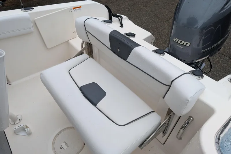 Slide: The Image of 2019 Wellcraft 222 Fisherman boat interior with Yamaha 200 engine, featuring cushioned seating. - 11