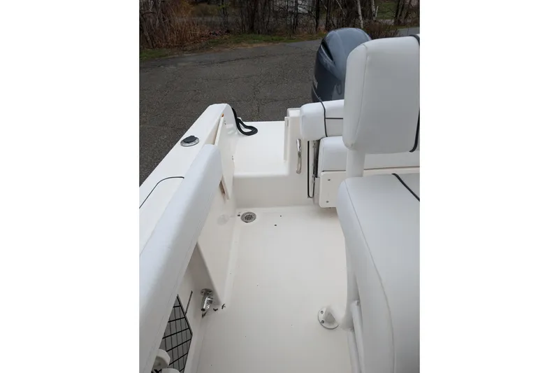 Slide: The Image of 2019 Wellcraft 222 Fisherman boat interior with white seating and deck. - 12