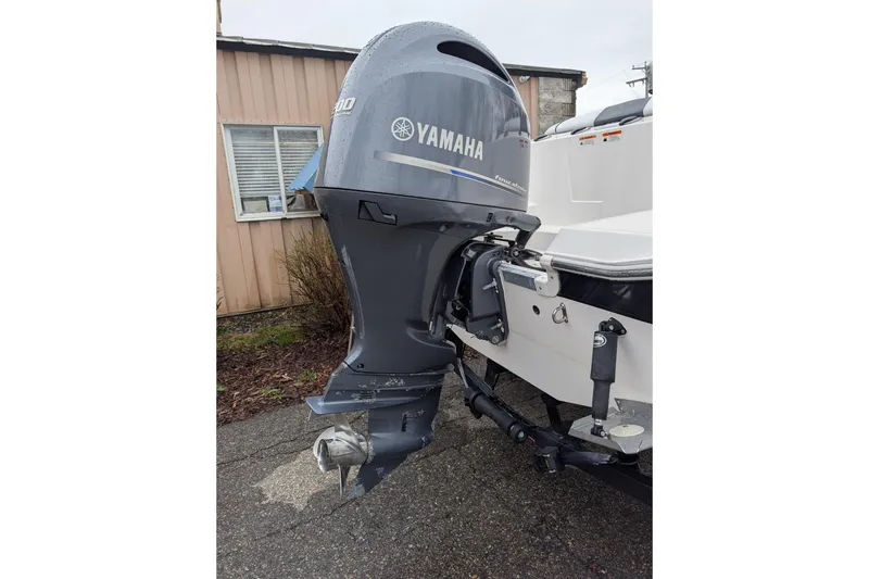 Slide: The Image of 2019 Wellcraft 222 Fisherman with Yamaha outboard motor, parked outdoors. - 14