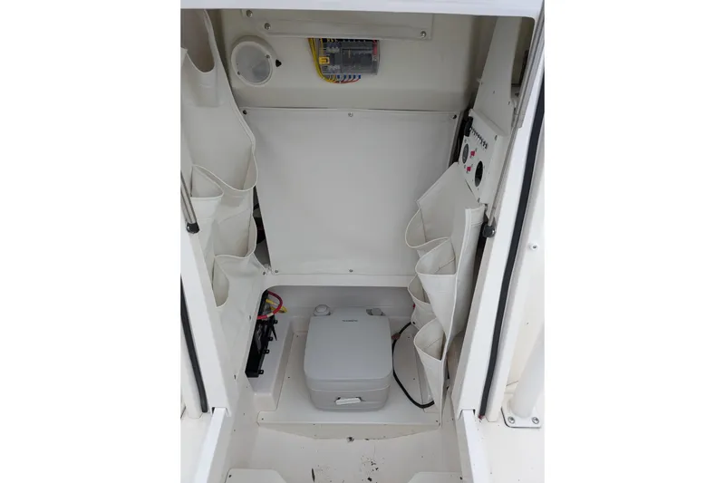 Slide: The Image of Interior of 2019 Wellcraft 222 Fisherman boat with storage compartments and portable toilet. - 5