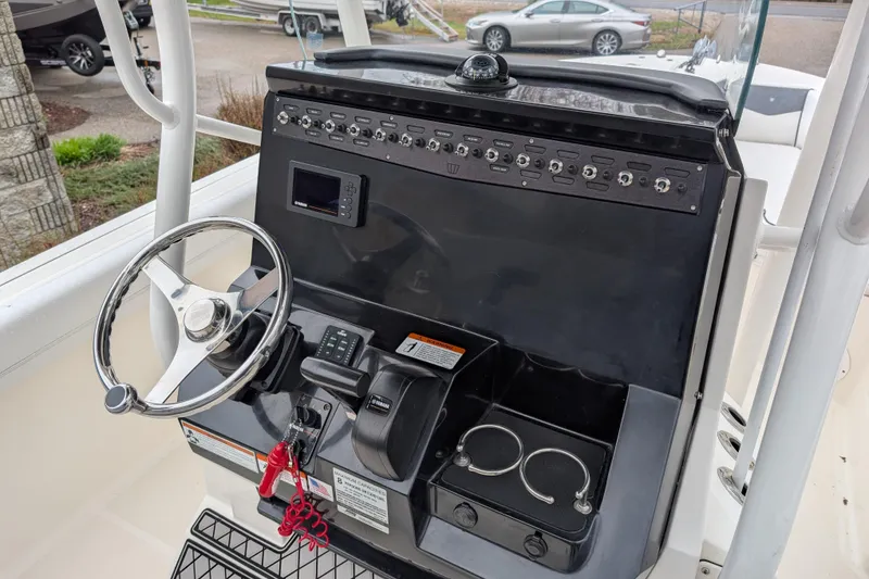 Slide: The Image of 2019 Wellcraft 222 Fisherman boat dashboard with steering wheel and control panel. - 7