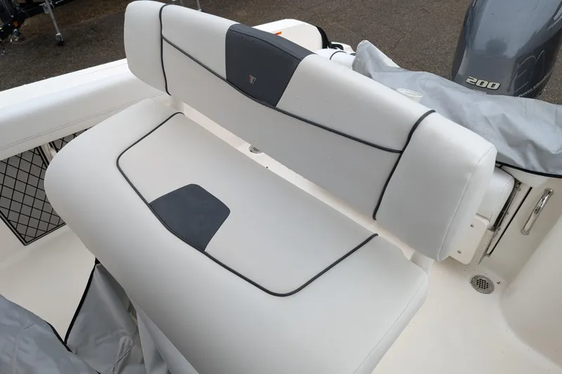 Slide: The Image of 2019 Wellcraft 222 Fisherman boat seat with white upholstery and black accents. - 8