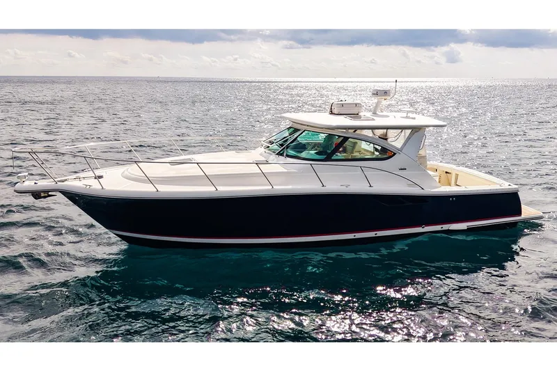 Slide: The Image of 2005 Tiara Yachts 3800 Open cruising on open water under a cloudy sky. - 2