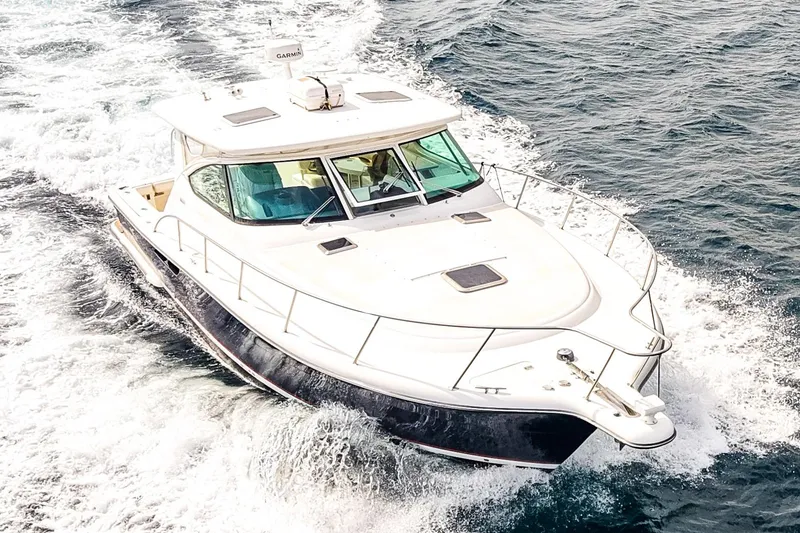 Slide: The Image of 2005 Tiara Yachts 3800 Open cruising on the ocean, creating a wake. - 4