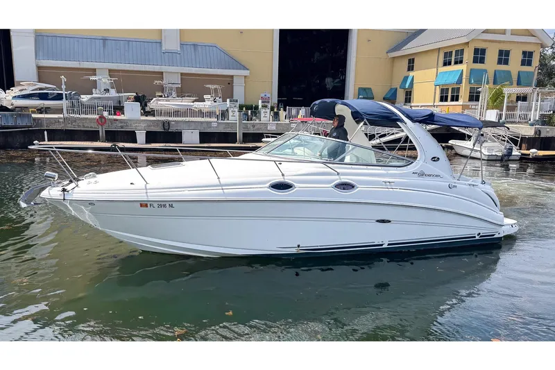 The Image of 2007 Sea Ray Sundancer 280 boat docked at marina, featuring sleek white design. - 0