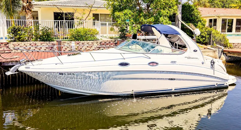 Slide: The Image of 2007 Sea Ray 280 Sundancer boat docked by waterfront homes. - 1