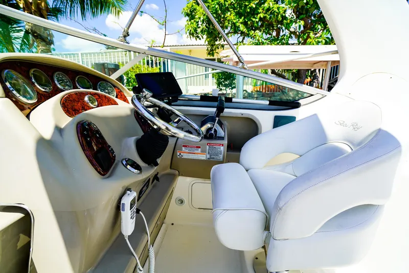 Slide: The Image of 2007 Sea Ray 280 Sundancer helm with white captain's chair and control panel. - 15