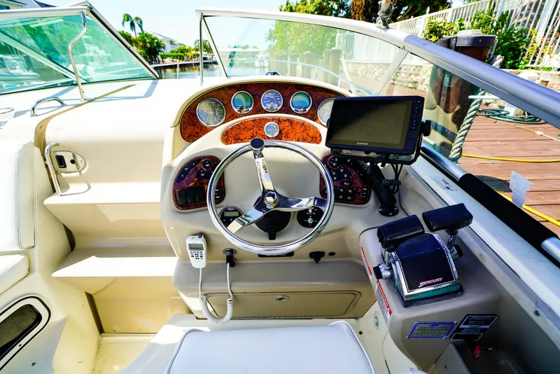 Slide: The Image of 2007 Sea Ray 280 Sundancer helm with steering wheel, gauges, and navigation system. - 16