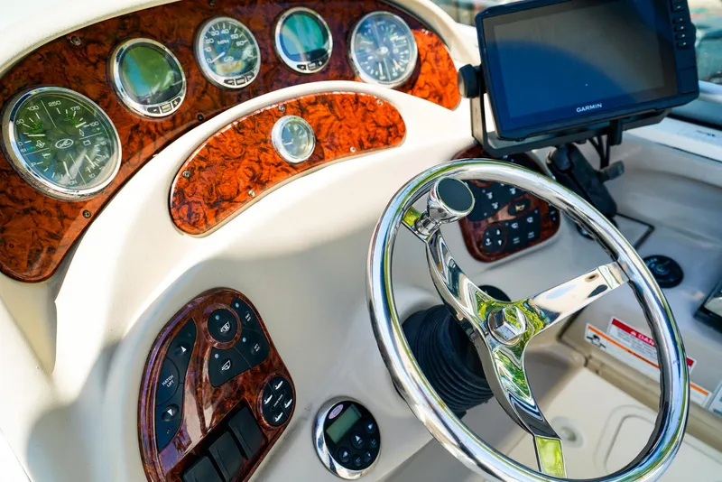 Slide: The Image of Dashboard of a 2007 Sea Ray 280 Sundancer boat with steering wheel and gauges. - 17