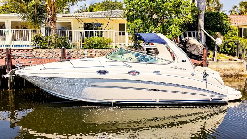 Slide: The Image of 2007 Sea Ray 280 Sundancer boat docked by waterfront homes. - 2