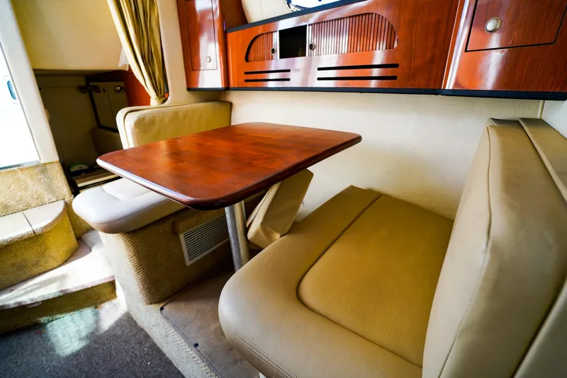 Slide: The Image of 2007 Sea Ray 280 Sundancer interior with cozy seating and wooden table. - 22