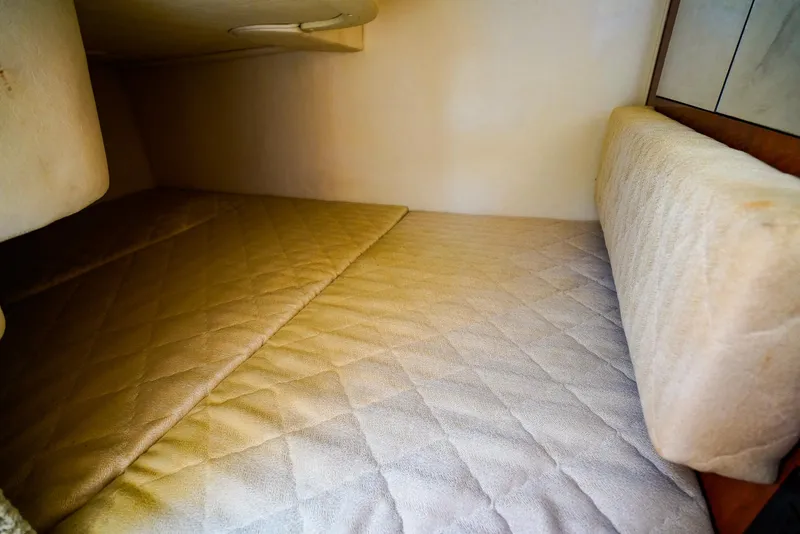 Slide: The Image of Interior cabin of 2007 Sea Ray 280 Sundancer with cushioned sleeping area. - 27