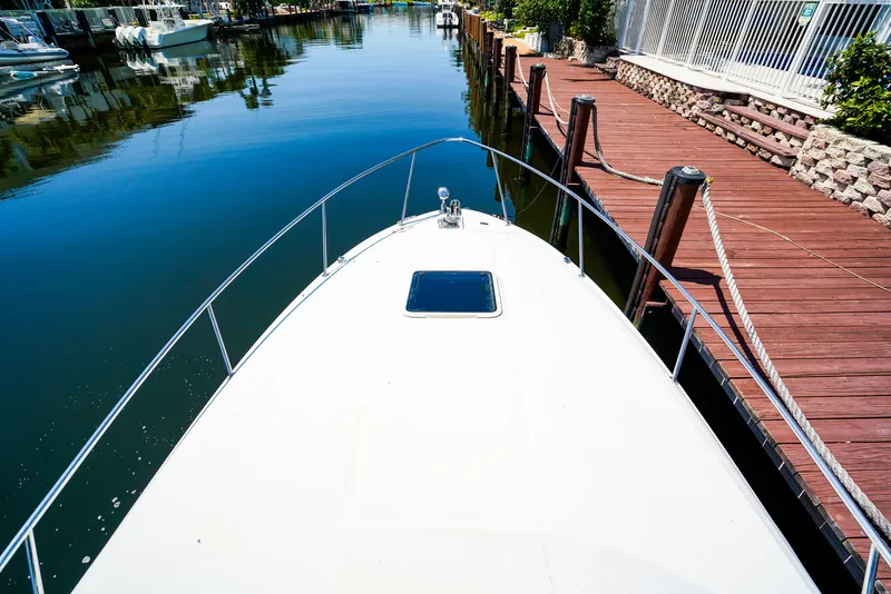 Slide: The Image of 2007 Sea Ray 280 Sundancer docked in a serene canal setting. - 29