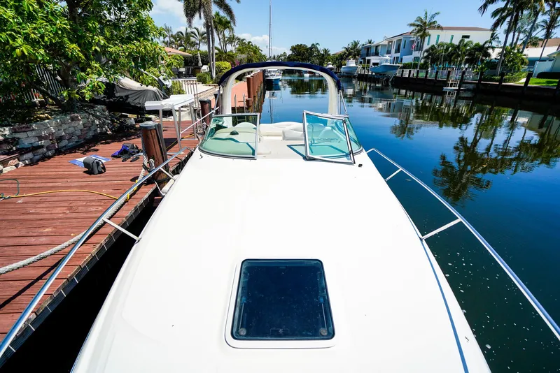 Slide: The Image of 2007 Sea Ray 280 Sundancer docked in a scenic canal with palm trees. - 30
