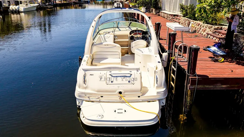 Slide: The Image of 2007 Sea Ray 280 Sundancer docked at a serene waterfront location. - 5