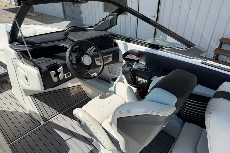 Slide: The Image of 2020 Nautique Super Air Nautique G25 boat interior with modern dashboard and seating. - 13