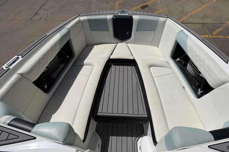 Slide: The Image of 2020 Nautique Super Air Nautique G25 boat interior with luxurious seating and cup holders. - 14