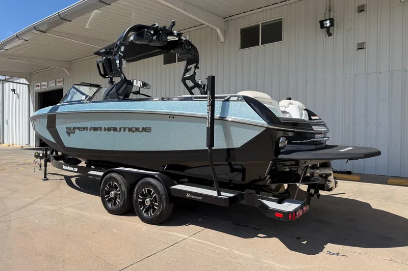 Slide: The Image of 2020 Nautique Super Air Nautique G25 boat on trailer, parked outside a building. - 3
