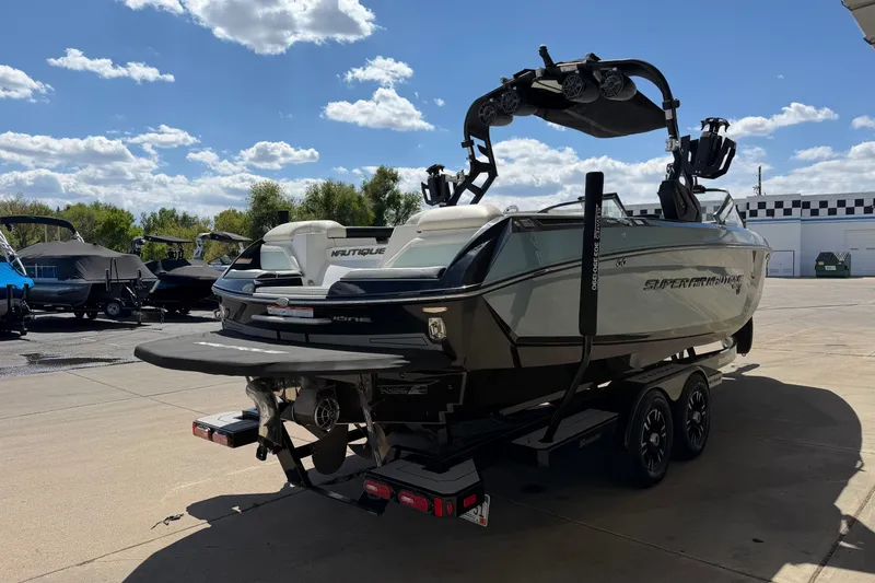 Slide: The Image of 2020 Nautique Super Air Nautique G25 boat on trailer under a sunny sky. - 6