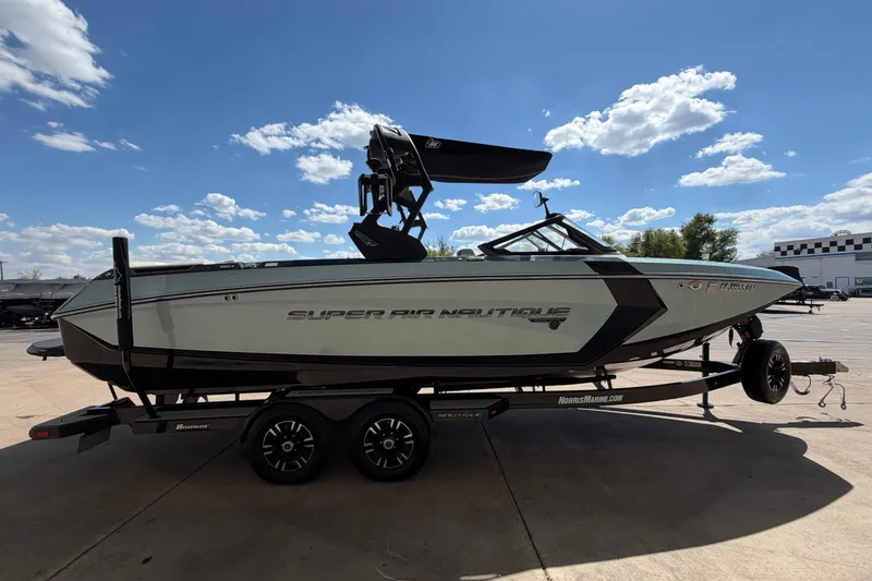 Slide: The Image of 2020 Nautique Super Air Nautique G25 boat on trailer under blue sky. - 7
