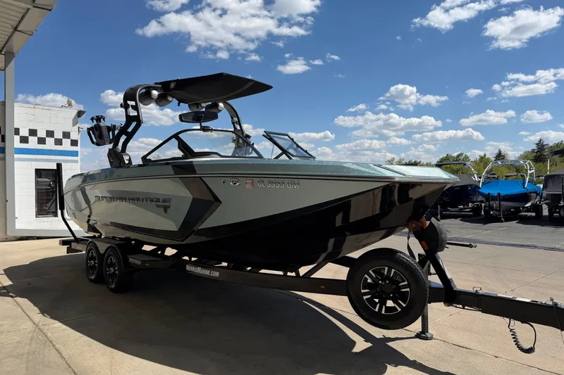 Slide: The Image of 2020 Nautique Super Air Nautique G25 boat on trailer under clear blue sky. - 8