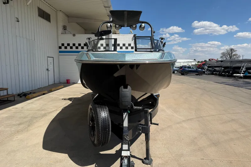 Slide: The Image of 2020 Nautique Super Air Nautique G25 boat on trailer, parked outdoors under blue sky. - 9